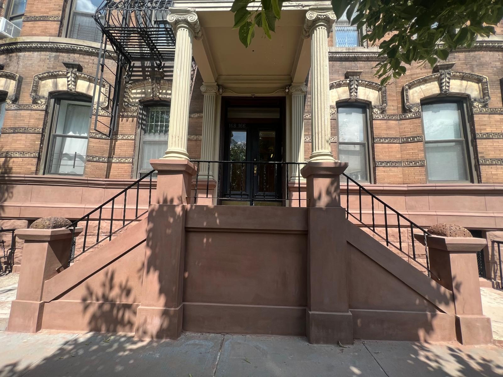 Brooklyn brownstone with restored columned portico, rebuilt stoop, and brick detail