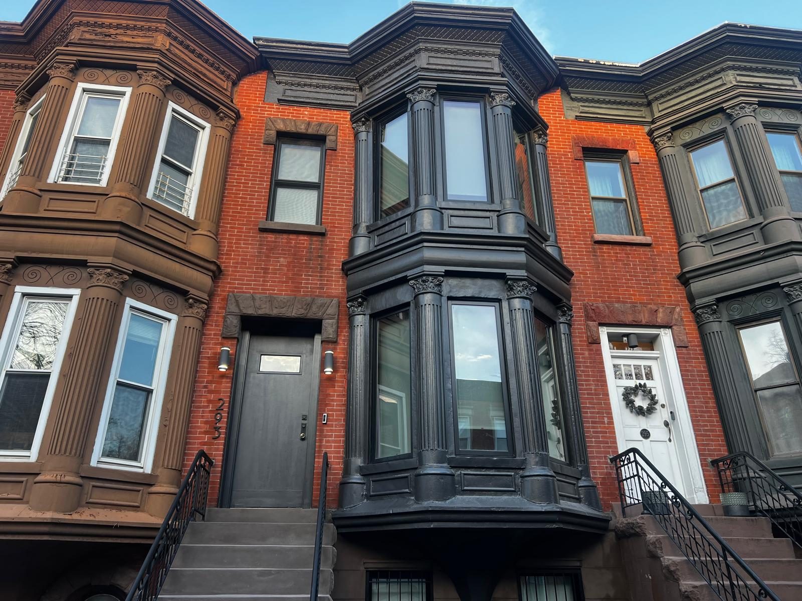 Restored brick and brownstone façade with bay window in Park Slope
