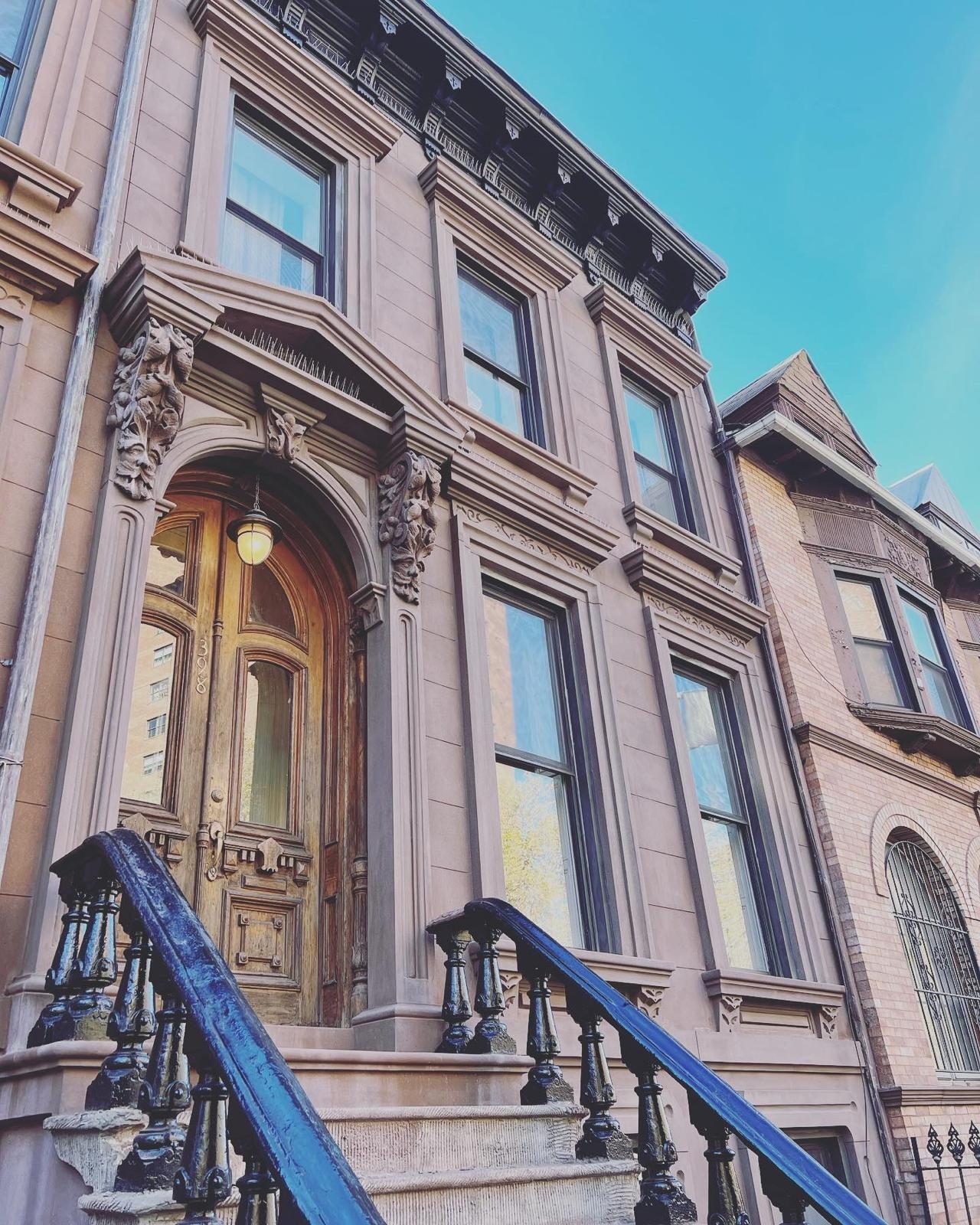 Italianate brownstone restoration with hand-carved corbels and arched wooden door in Park Slope Brooklyn