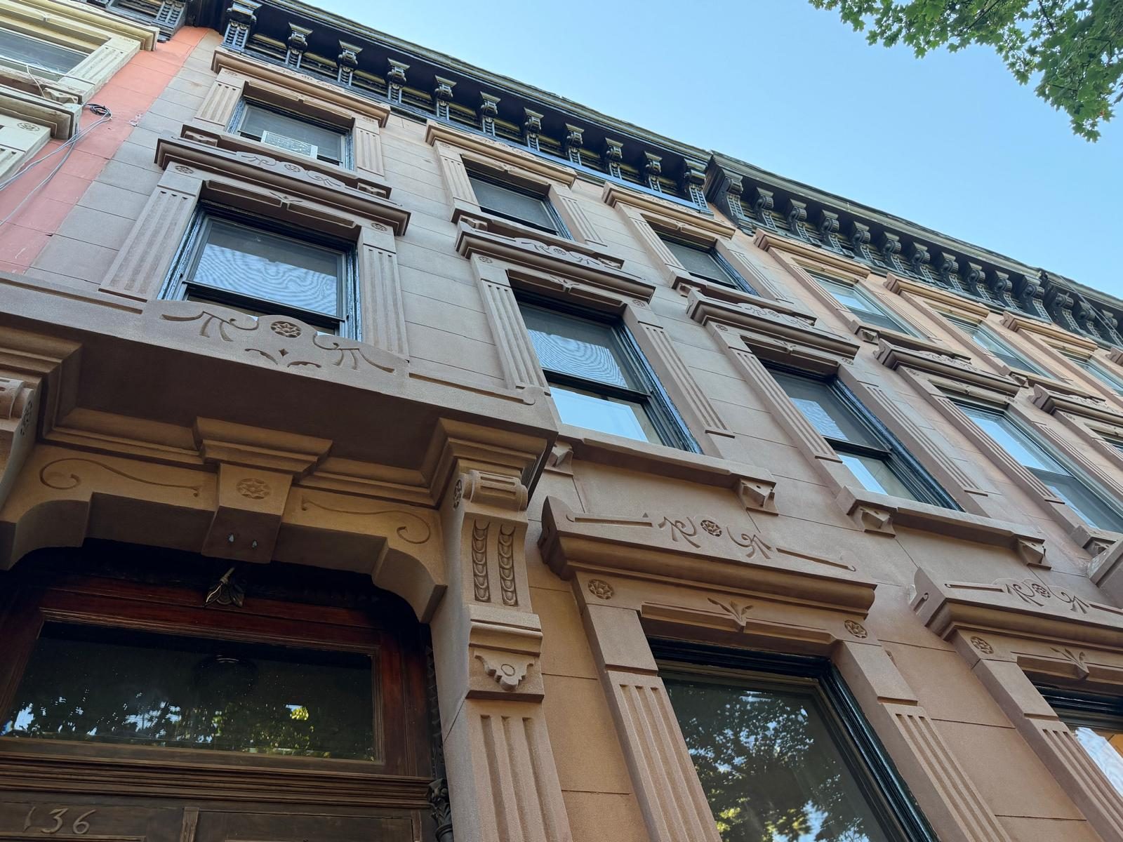 Brooklyn brownstone façade restoration with hand-finished brownstone units and matched mortar